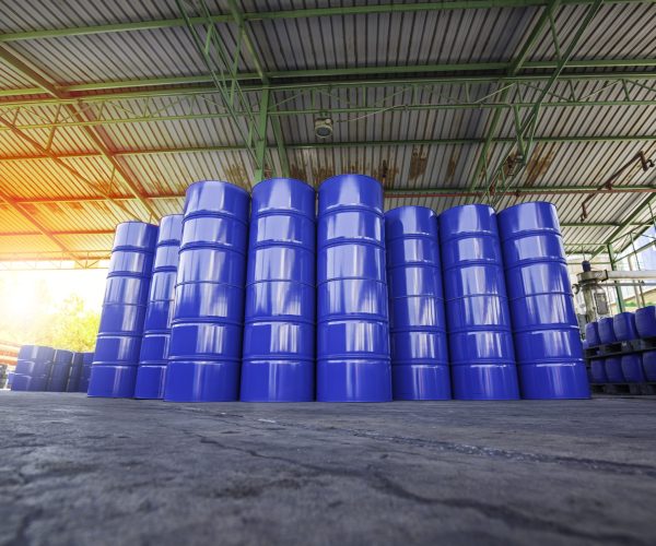 Oil barrels blue or chemical drums vertical stacked up sun light orange