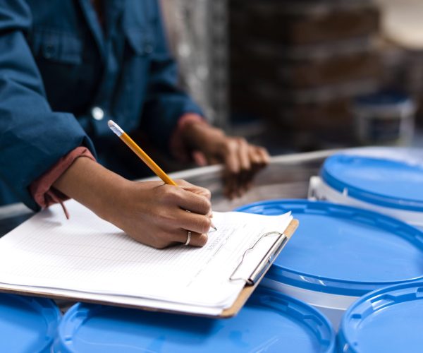 woman-worker-taking-notes-warehouse