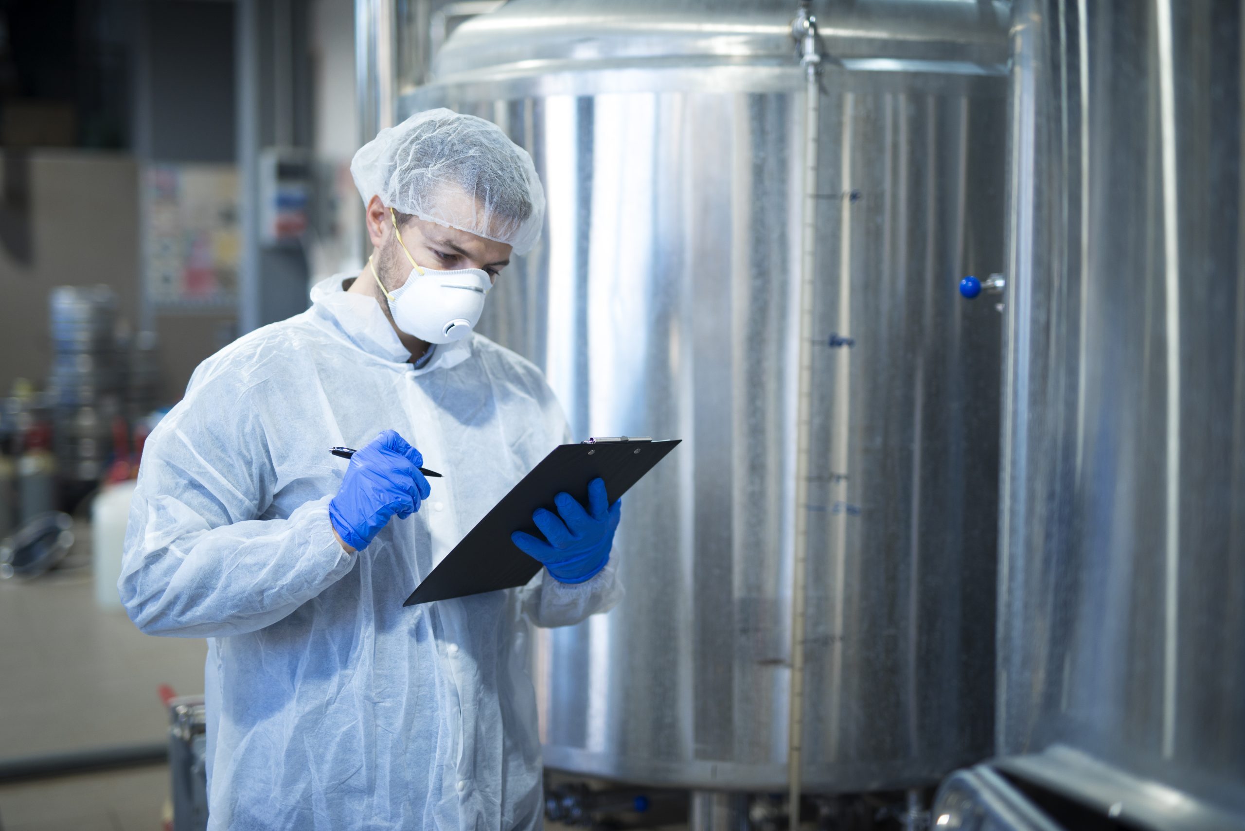 Technologist expert controlling production in pharmaceutical or food processing factory.